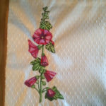 maroon red holly hocks on beige table mat