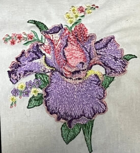 Iris pillow 13x13. Stitch out closeup.